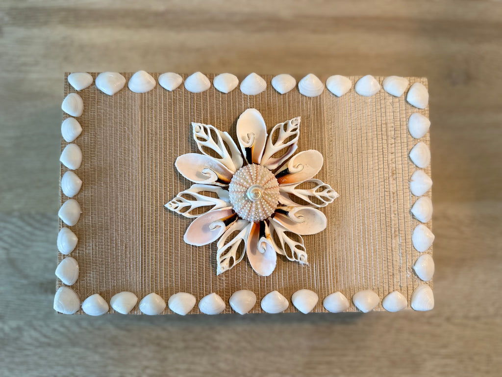 Handcrafted rattan shell box with blush and cream seashells on woven basket with lined interior, 10.75 x 6.75 x 3.75 inches