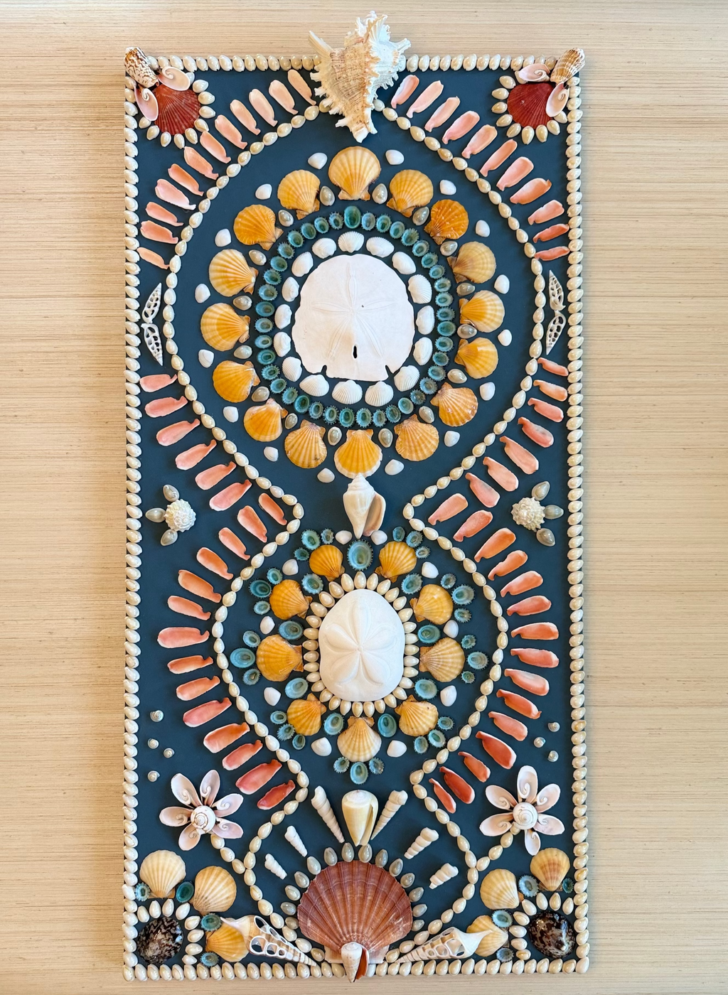 Tempe star shell panel with repeating mandala designs in earth tones, turquoise, and coral shells on dark background, 18 x 36 inches